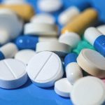 an assortment of opioid prescription pills scattered on a table