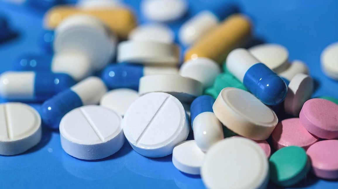 an assortment of opioid prescription pills scattered on a table