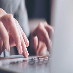 Hands typing on a keyboard