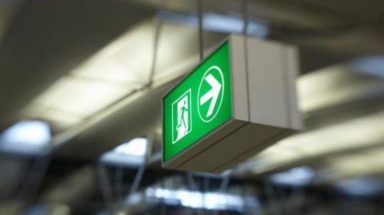 Green fire exit sign close-up Green fire exit sign close-up