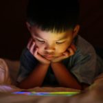 Little boy reading from a tablet