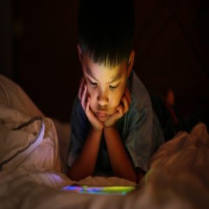 Little boy reading from a tablet