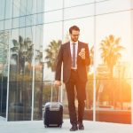 Business man with sun reflected behind him conducts a dynamic risk assessment