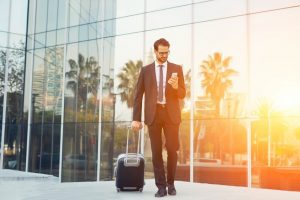 Business man with sun reflected behind him conducts a dynamic risk assessment