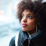 African American woman looking out of the window during a bus ride