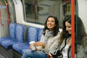 Two young women riding the train