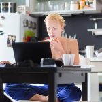 An employer looks at their working from home guide, while working from home