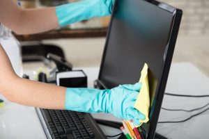 Person wiping monitor screen