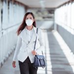 Woman wearing PPE on her return to work