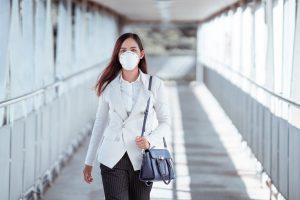 Woman wearing PPE on her return to work