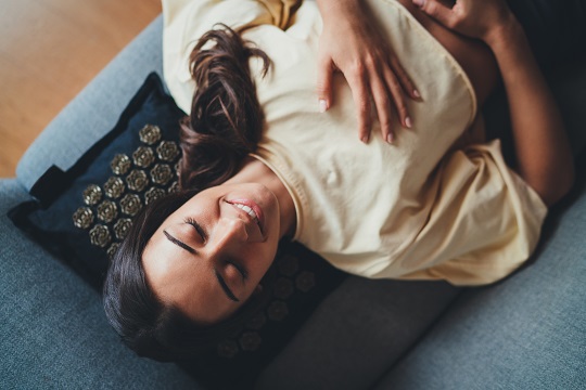 Top,View,Of,Young,Happy,Beautiful,Woman,Relaxing,With,Closed