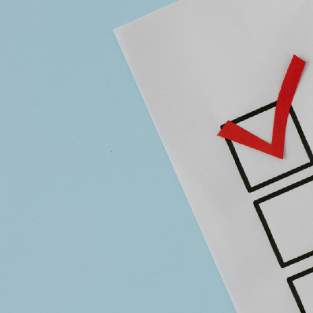 Graphic of a survey with a ticked checkbox.