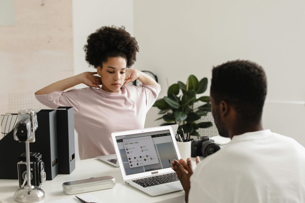 An office worker stretching to reduce the risk of MSDs