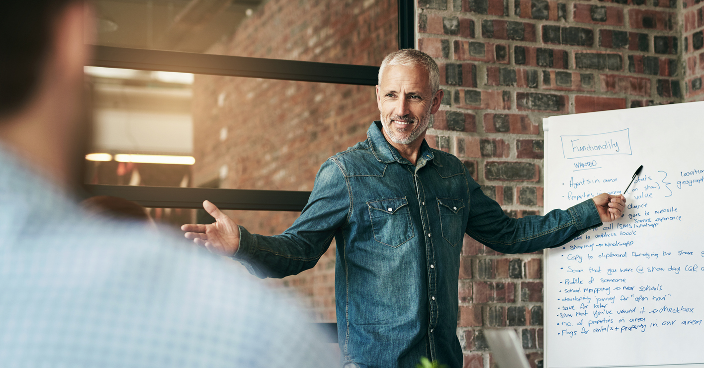 Manager, presentation and meeting with whiteboard, discussion and planning for workshop. Businessman, training and collaboration for teamwork, brainstorming and goals for creative business research