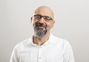 Man with glasses smiles