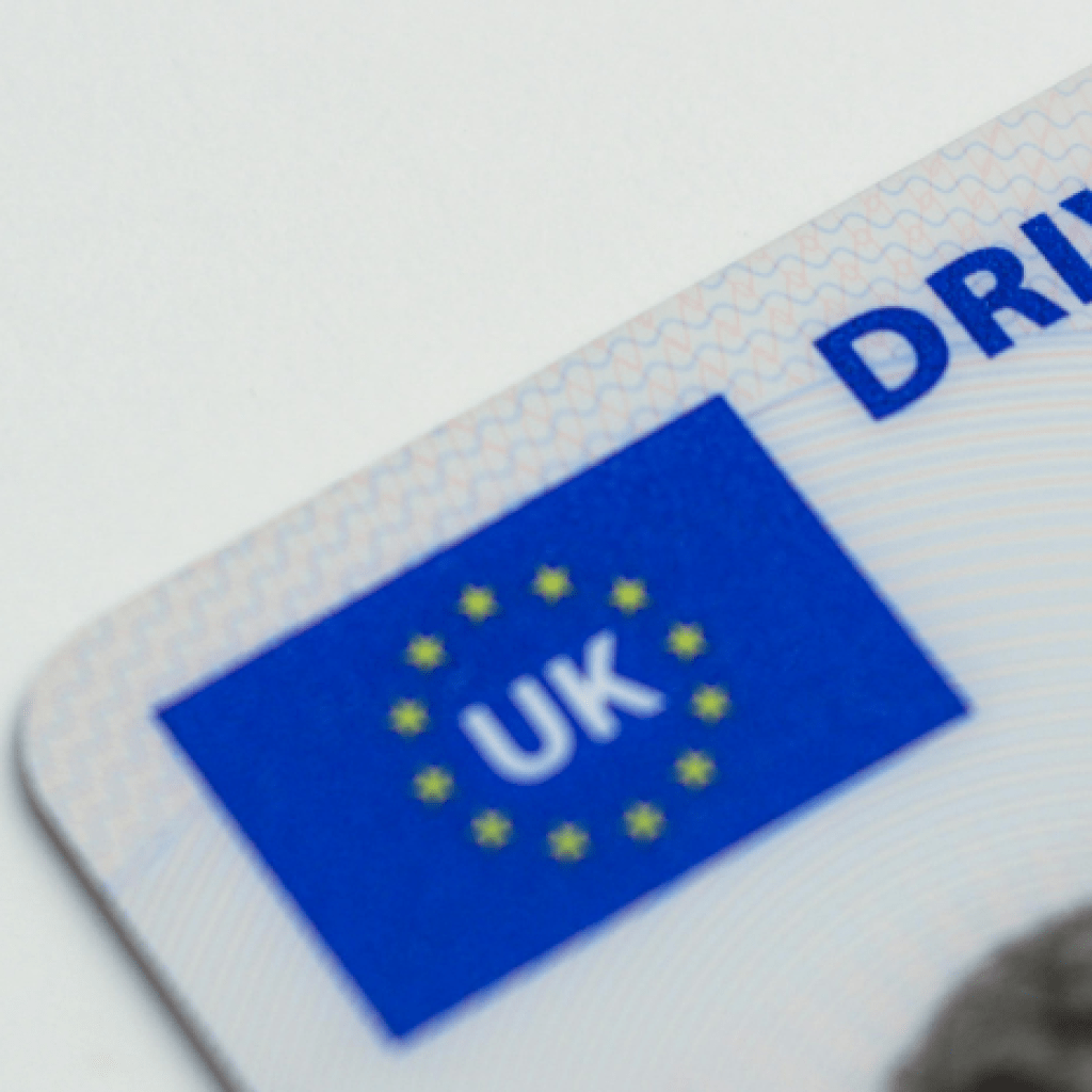A close-up of the top corner of a UK driving licence.
