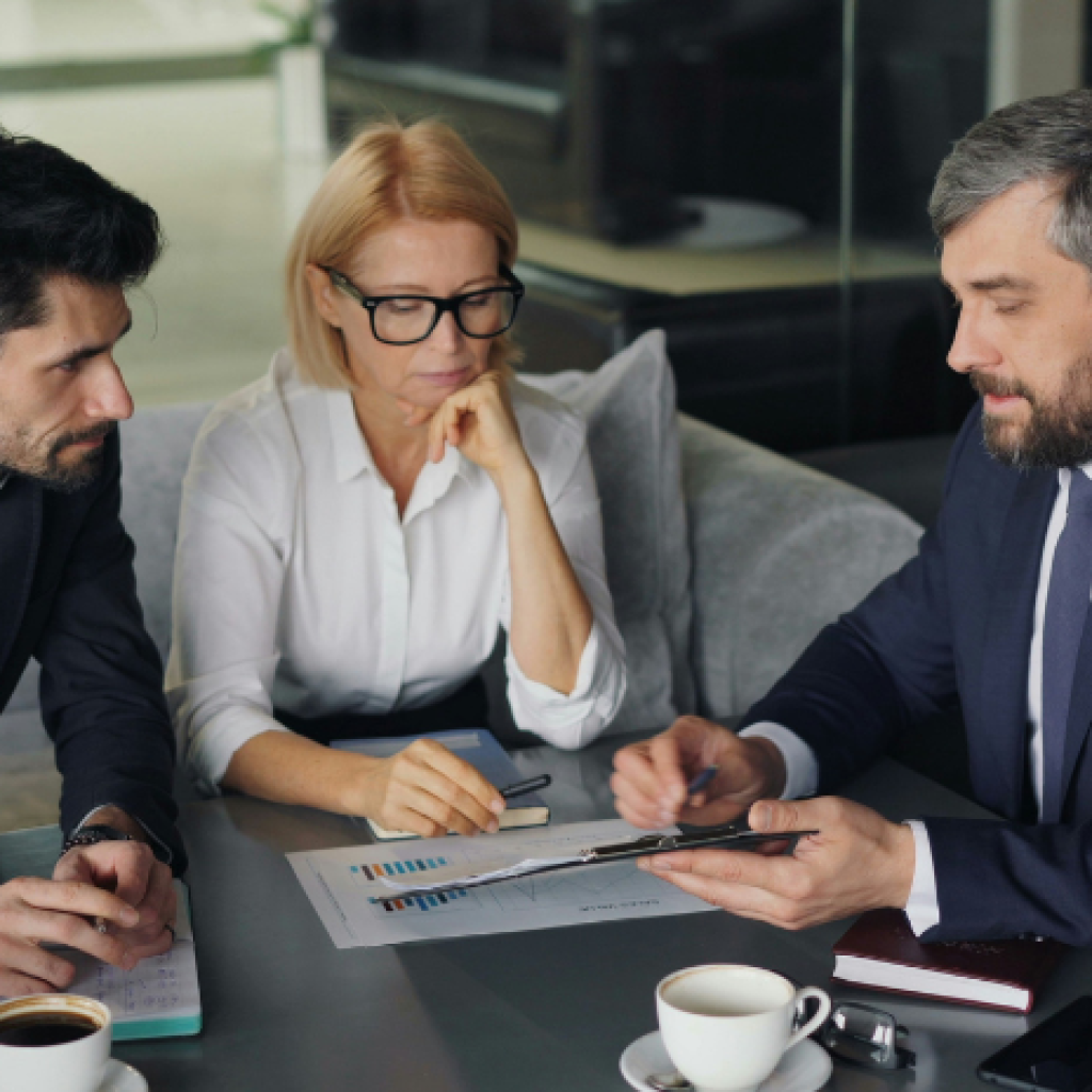 An insurance broker discussing a document with clients