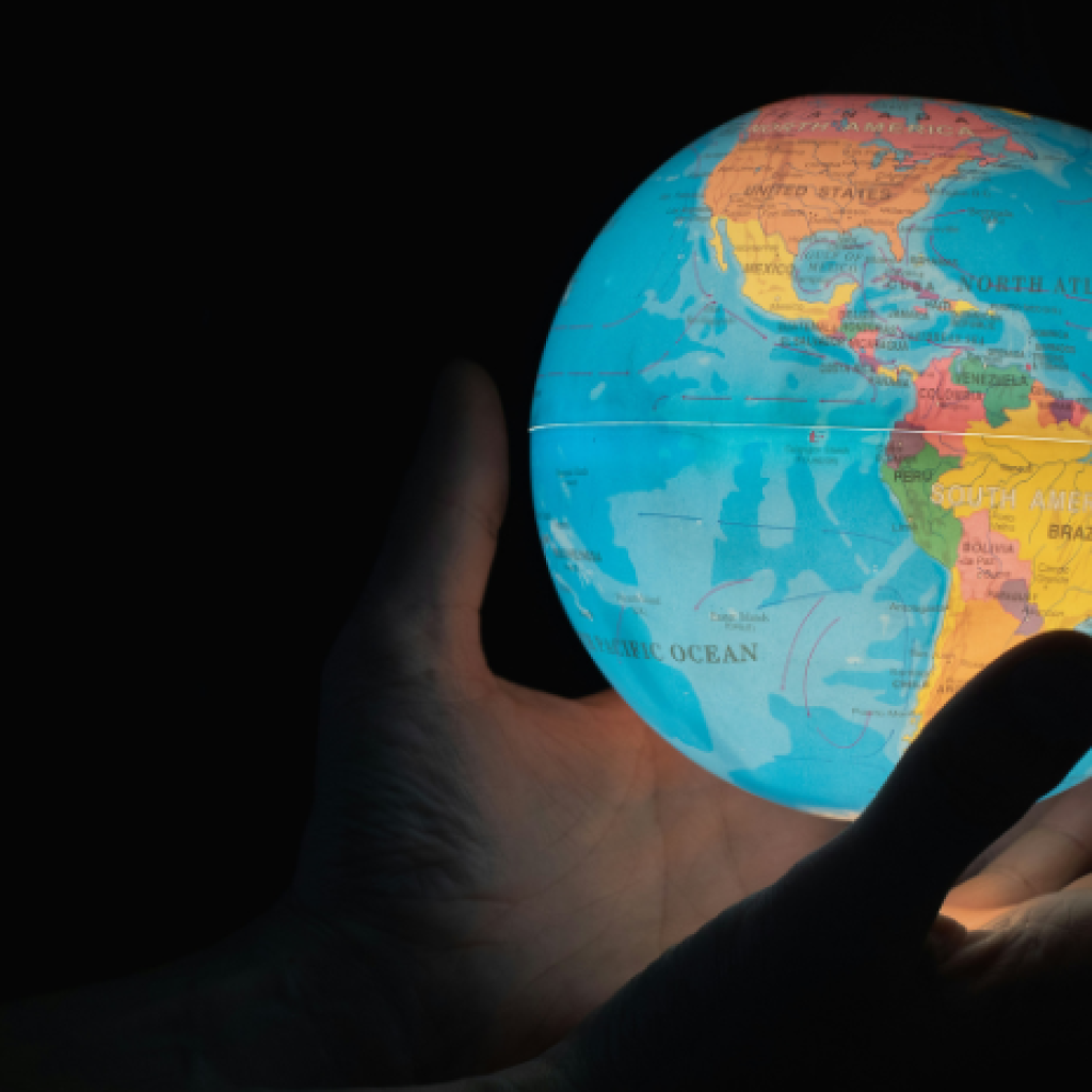 A globe lantern in the dark levitating above a pair of cupped hands