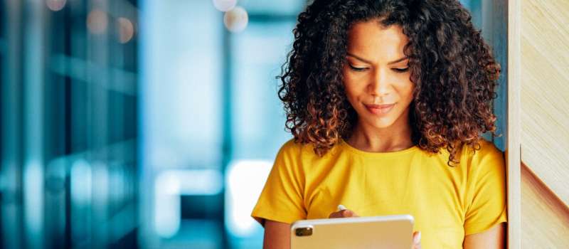 Businesswoman signing document with digital signature on tablet